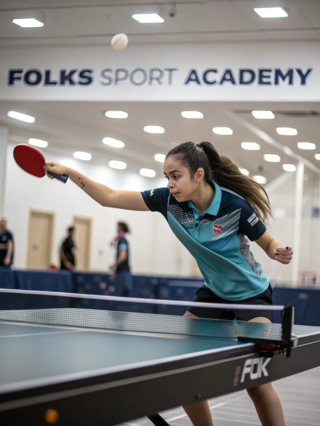 A focused table tennis player practicing a forehand loop during a training session at ETREUX TENNIS DE TABLE.